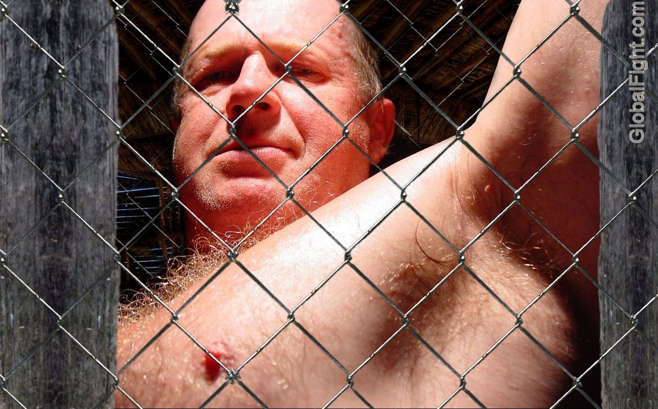 caged male bondage bdsm chain link fence fighting match