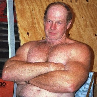 cleancut irish man sitting shirtless post wrestling event showing off hairychest furry pecs