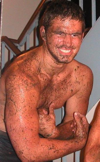 muscular man muddy wrestling
